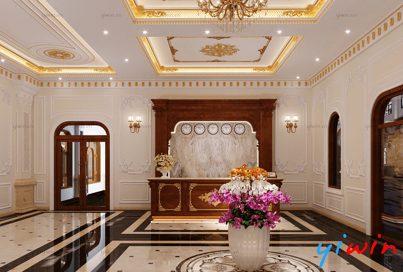 Thiết kế sảnh khách sạn tân cổ điển có chi tiết mạ vàng và đèn chùm pha lê lớn tạo điểm nhấn q...png